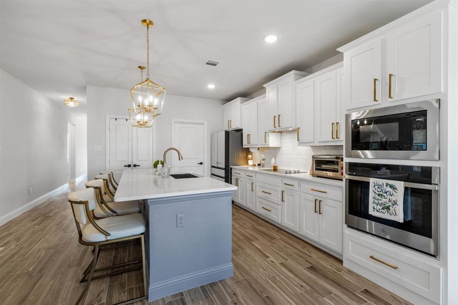 The kitchen includes a spacious pantry for ample storage and easy organization. Just off the kitchen is a large utility room, providing convenient access for laundry and additional household tasks.