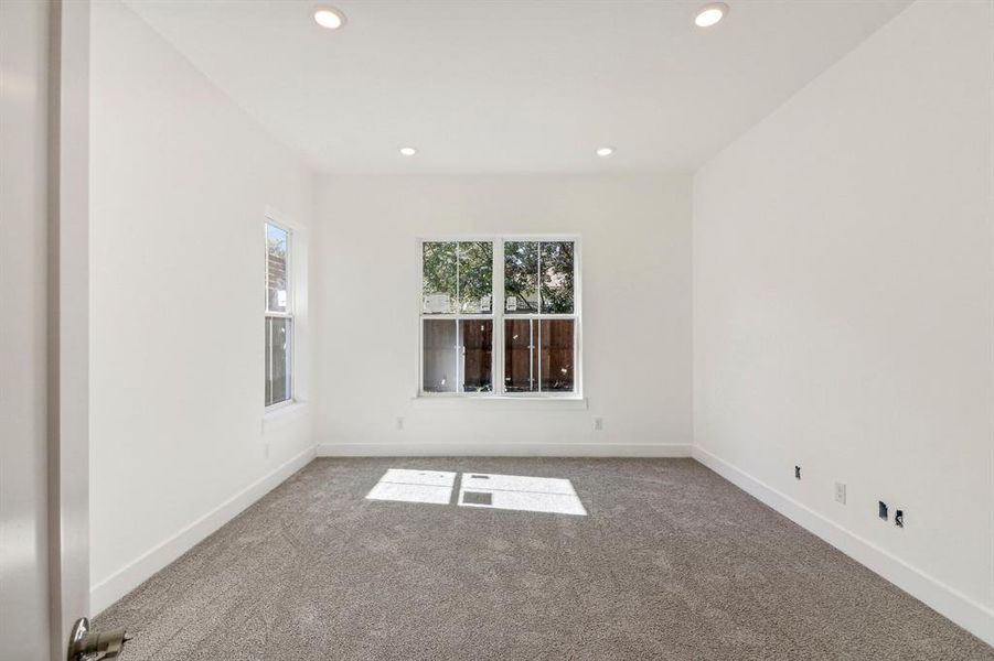 Carpeted empty room featuring recessed lighting and baseboards