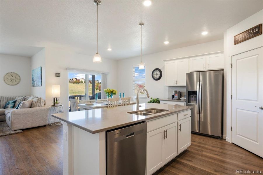 Modern finishes, pendant lighting, and Whirlpool appliances bring together style and function.