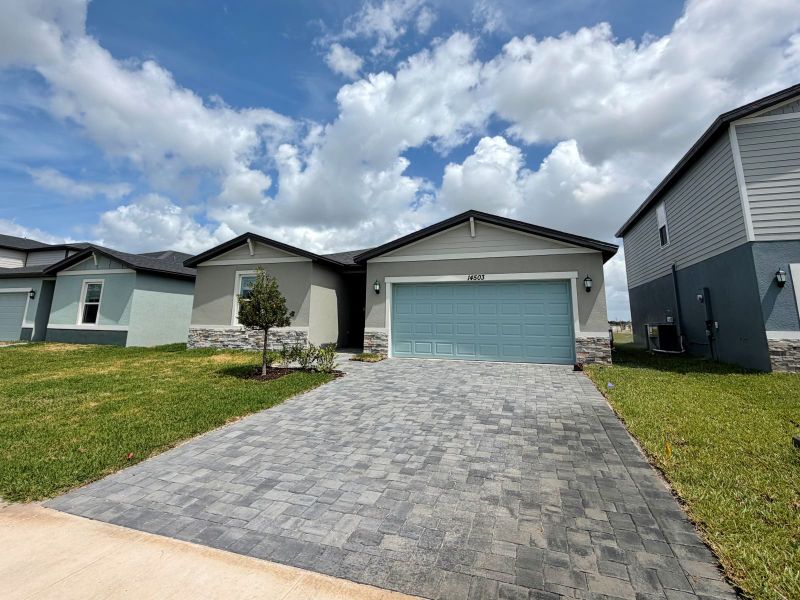 Front exterior of a new home in Meritage Homes at Terra Lago - Classic Series, Indiantown, FL, highlighting curb appeal (Image 10).