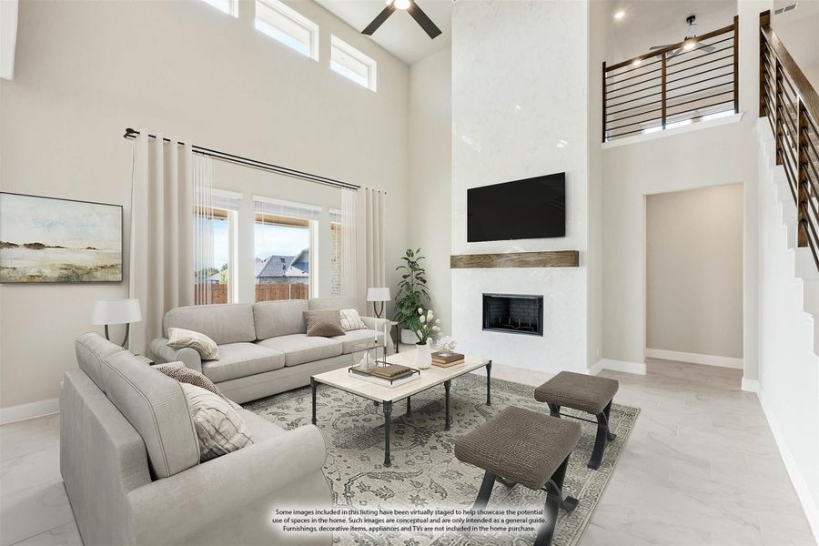 Open living room with two-story ceiling, fireplace, ceiling fan, and staircase overlook