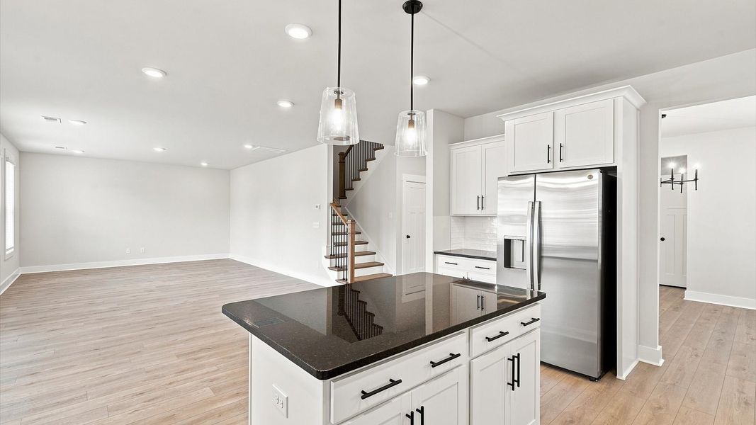 Exceptional culinary space with a center island and eye-catching pendant lights at Walnut Ridge