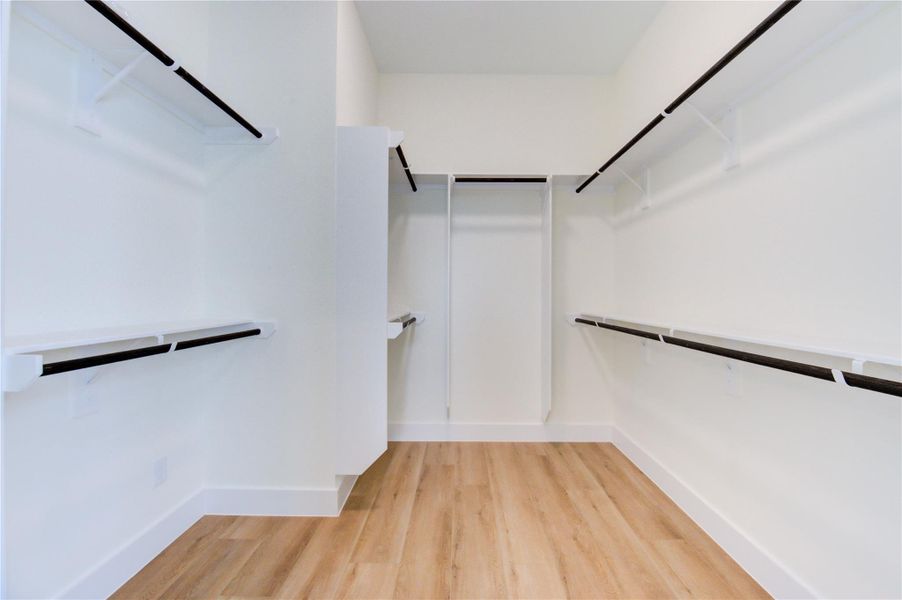 Spacious walk-in closet with ample shelving and storage for all your wardrobe needs. Spacious walk-in closet with ample shelving and storage for all your wardrobe needs.