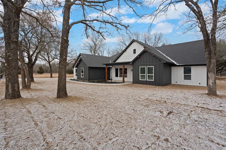 Modern farmhouse with board and batten siding and roof with shingles