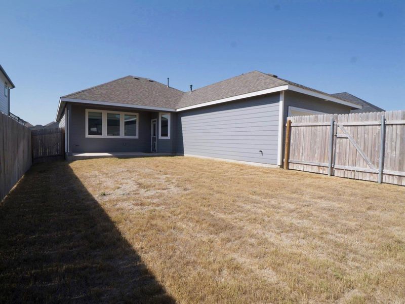 Rear view of property featuring a fenced backyard, a patio, a shingled roof, and a gate Rear view of property featuring a fenced backyard, a patio, a shingled roof, and a gate