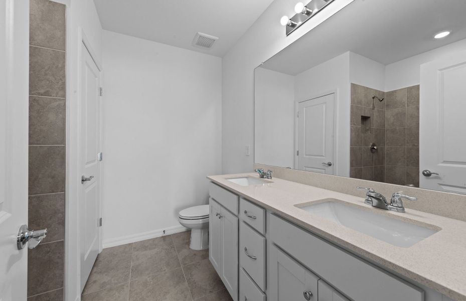 Owner's bathroom with dual-sink vanity and spacious shower Owner's bathroom with dual-sink vanity and spacious shower