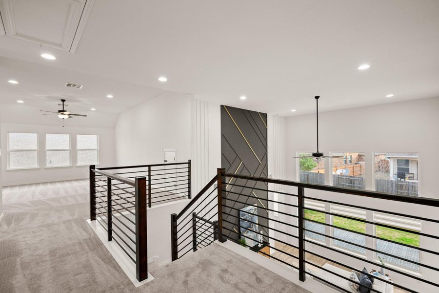 A horizontal black stair railing and designer accent walls add a clean, contemporary edge. A horizontal black stair railing and designer accent walls add a clean, contemporary edge.