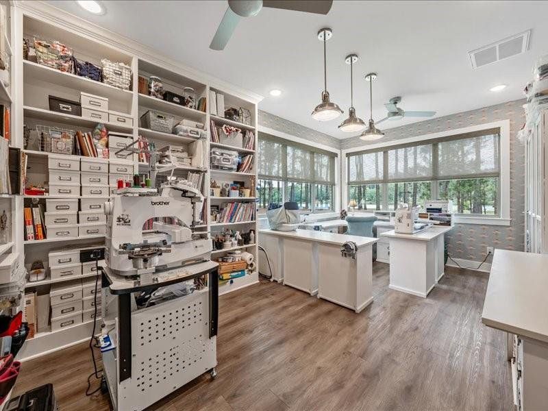 This is a 200sf space off the garage that is connected to the main HVAC system.  With custom shelving and best views in the house, a custom closet and wallpaper, this currently serves as a craft/sewing room.