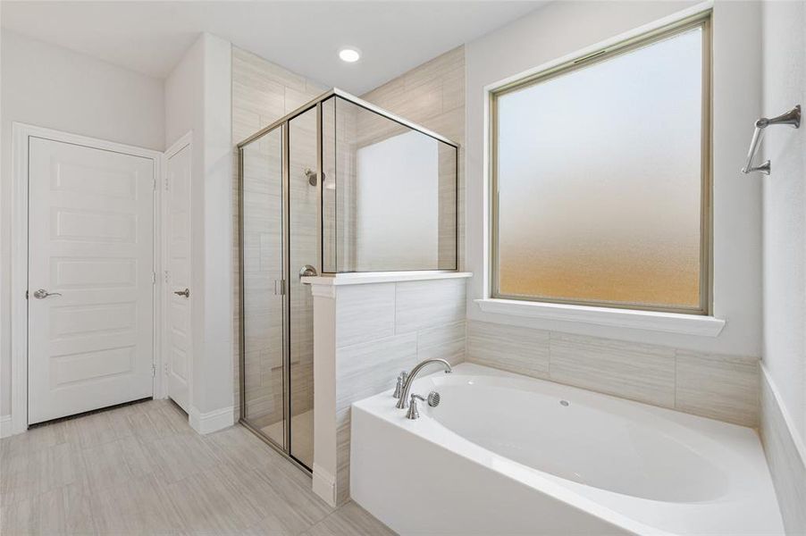 Full bath with a garden tub and a shower stall