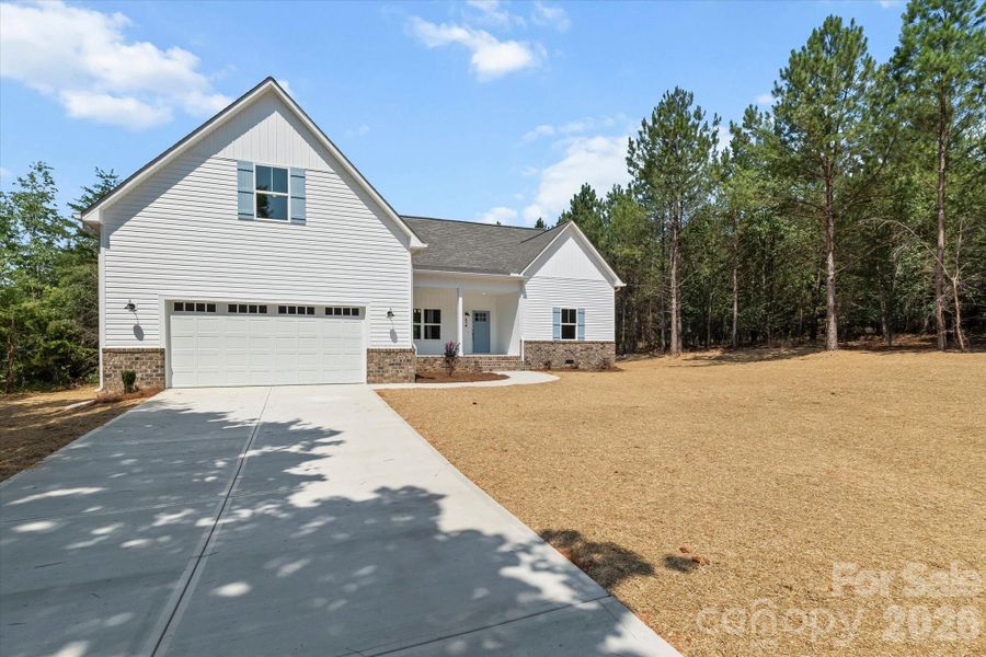 Front exterior of a new home in , Troutman, NC, highlighting curb appeal (Image 18).