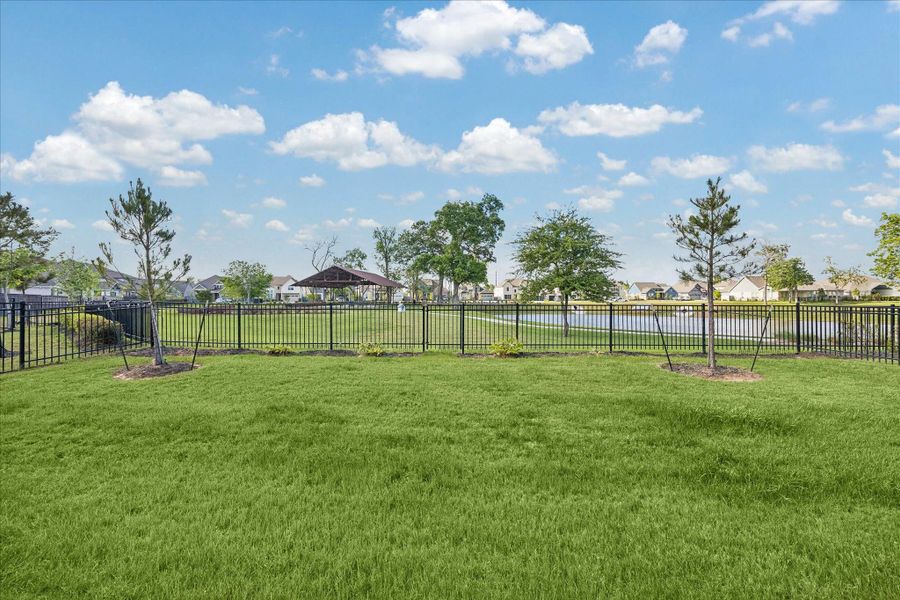 Backyard opens to unobstructed water and greenbelt views, offering a rare sense of space and privacy. Wrought iron style fencing preserves the sightlines while creating a seamless connection to the surrounding landscape. Backyard opens to unobstructed water and greenbelt views, offering a rare sense of space and privacy. Wrought iron style fencing preserves the sightlines while creating a seamless connection to the surrounding landscape.