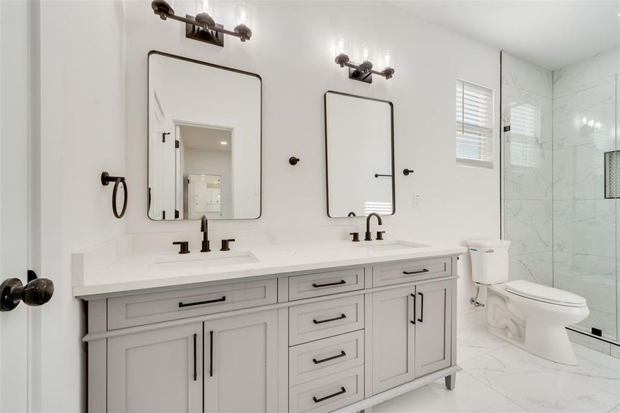 Bathroom featuring vanity, toilet, and walk in shower