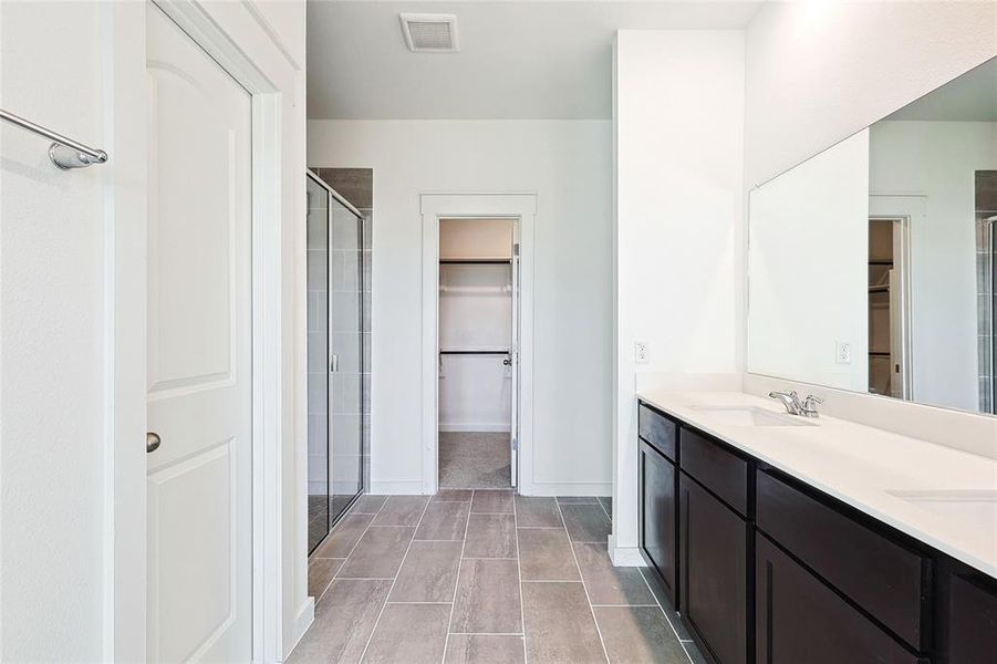 Bathroom featuring vanity and an enclosed shower