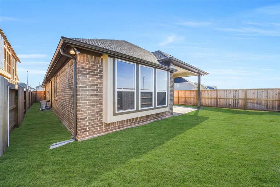 Exterior details and patio area of a home in Sunterra, Katy (Image 25).