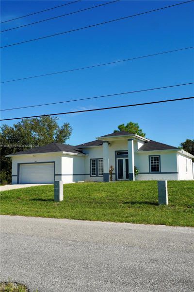 Front exterior of a new home in , Lehigh Acres, FL, highlighting curb appeal (Image 34).