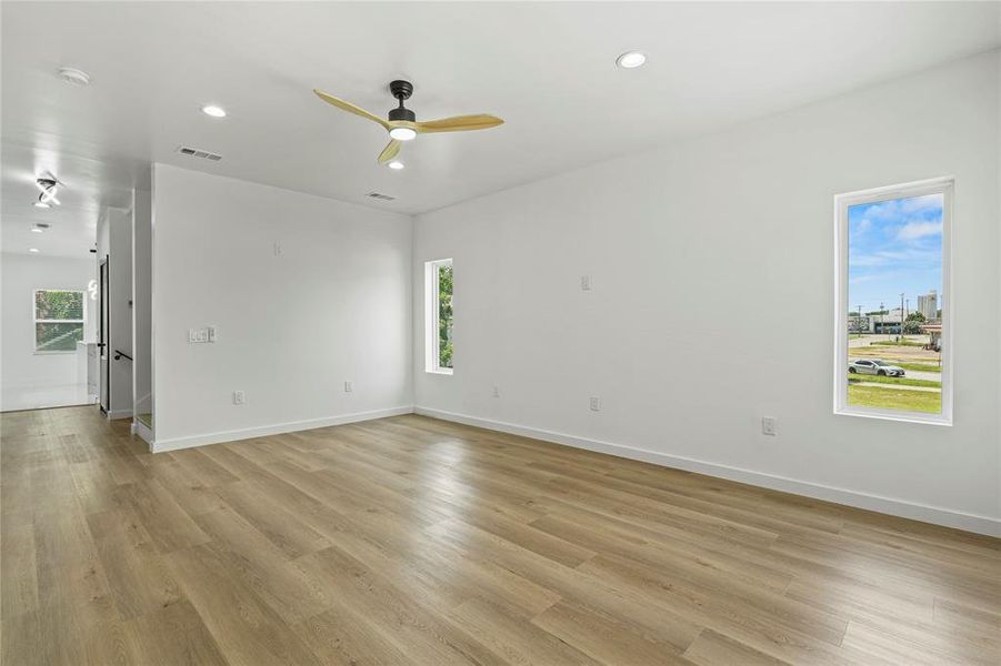 Spare room with light wood finished floors, recessed lighting, a smoke detector, and ceiling fan Spare room with light wood finished floors, recessed lighting, a smoke detector, and ceiling fan