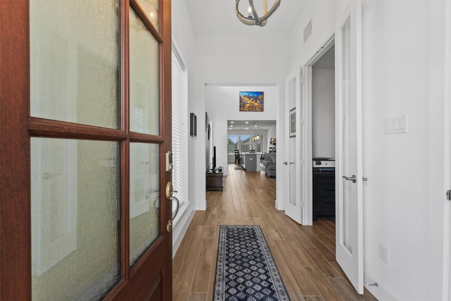 Step inside through an elegant 8-foot-tall front door to a bright and welcoming entryway with soaring ceilings. This grand entrance sets the tone for the rest of the home's open and modern design.