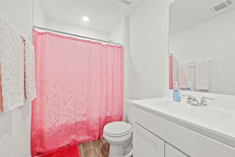 Conveniently located for the secondary bedrooms, this clean, neutral bathroom offers plenty of space and a simple, modern design.