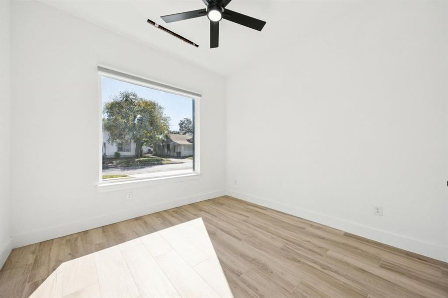 Spare room with light wood-style flooring and ceiling fan
