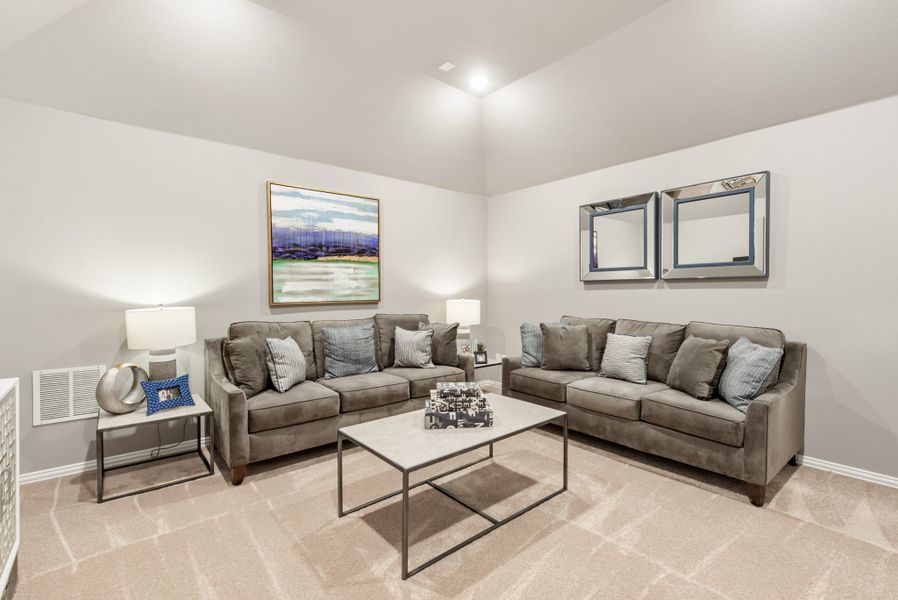 Living room with two gray sofas, coffee table, and high vaulted ceiling
