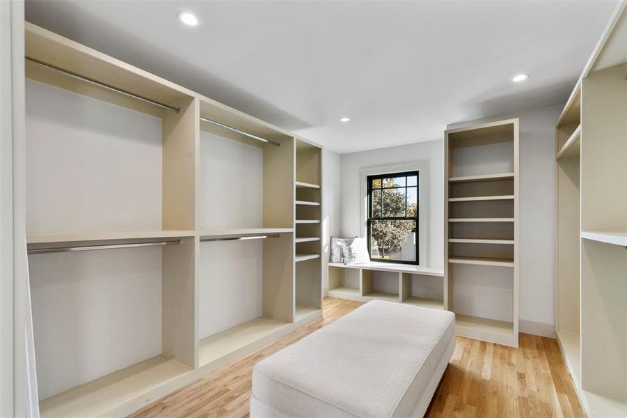 Spacious closet with light hardwood / wood-style flooring