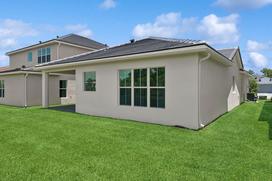 Front exterior of a new home in Salerno Reserve - Single Family, Stuart, FL, highlighting curb appeal (Image 2). Front exterior of a new home in Salerno Reserve - Single Family, Stuart, FL, highlighting curb appeal (Image 2).