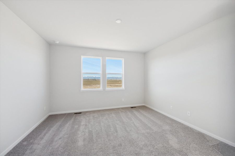 A room with a window and a carpet. A room with a window and a carpet.