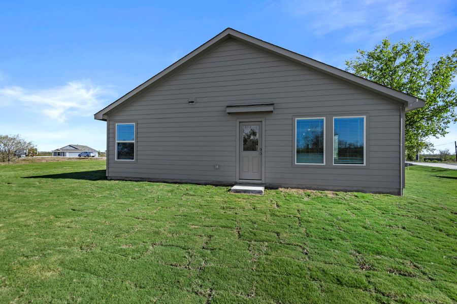 Back of house featuring a lawn Back of house featuring a lawn