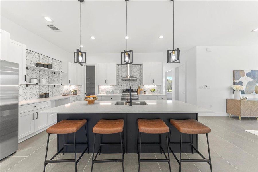 Kitchen with stainless steel refrigerator, backsplash, open shelves, light countertops, and recessed lighting Kitchen with stainless steel refrigerator, backsplash, open shelves, light countertops, and recessed lighting