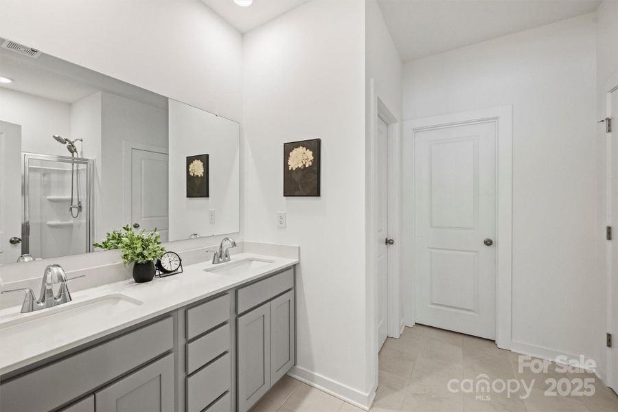 Enjoy your spa-like bathroom with dual sinks and tile floor.