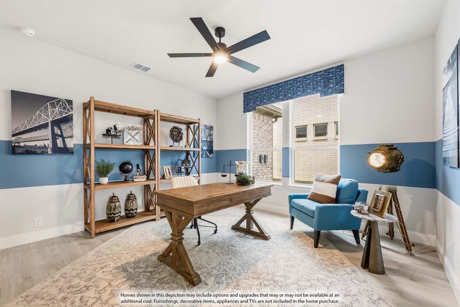 Home office with wood desk, open shelving, blue accent walls, and ceiling fan