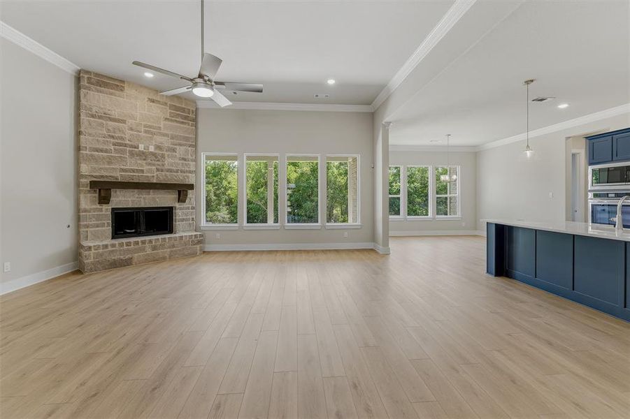 Spacious open-concept living area featuring light wood-finish flooring