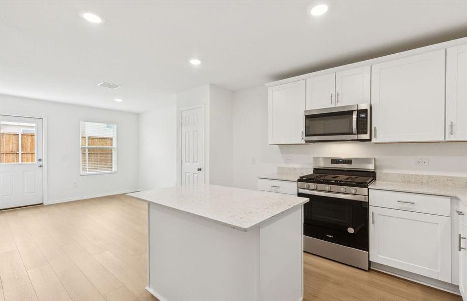 Large island overlooking gathering room and dining areas Large island overlooking gathering room and dining areas