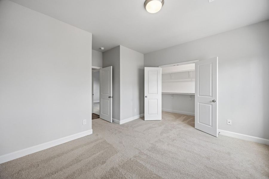 Room to Grow. The spacious secondary bedroom features a walk-in closet and plenty of natural light.