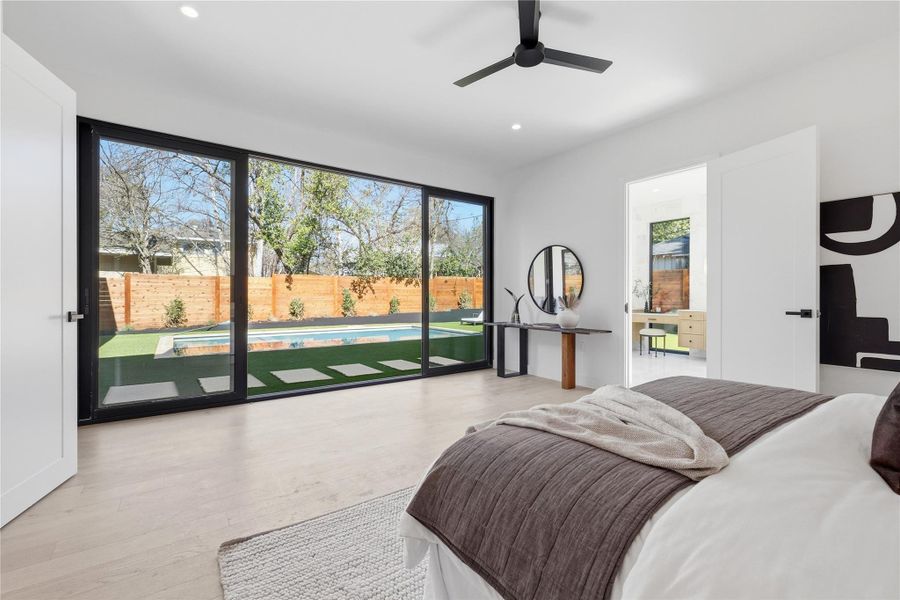 Bedroom featuring access to exterior, light wood-type flooring, a ceiling fan, and recessed lighting