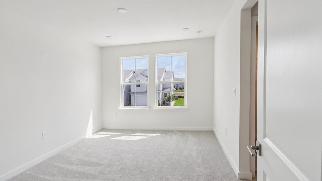 Primary Suite with en suite bath with dual sinks in the Monterey End Townhome by DRB Homes - Cyrene at Harmony in St Cloud FL