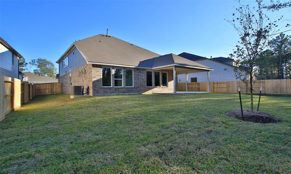 Exterior details and patio area of a home in The Woodlands Hills, Willis (Image 19).