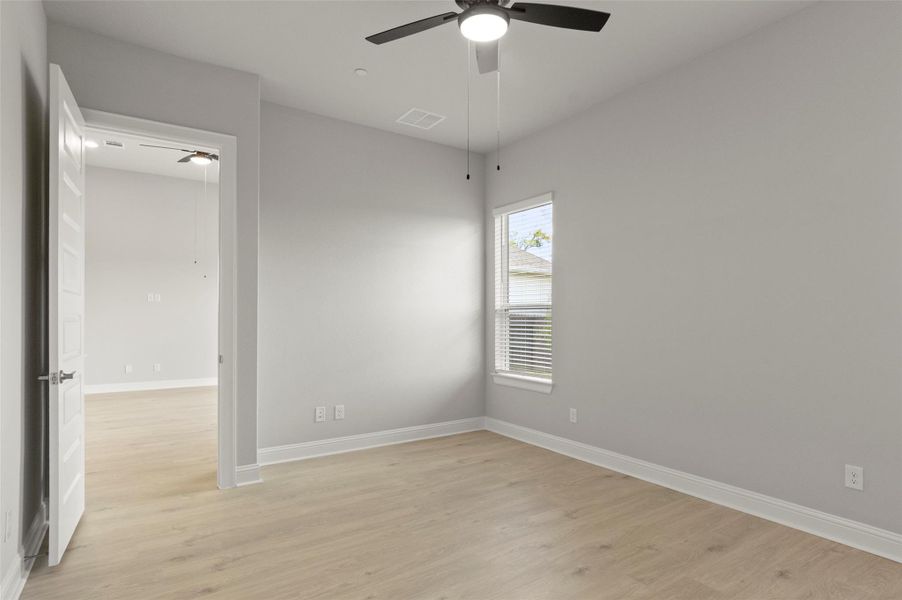 Unfurnished room with light wood finished floors and ceiling fan