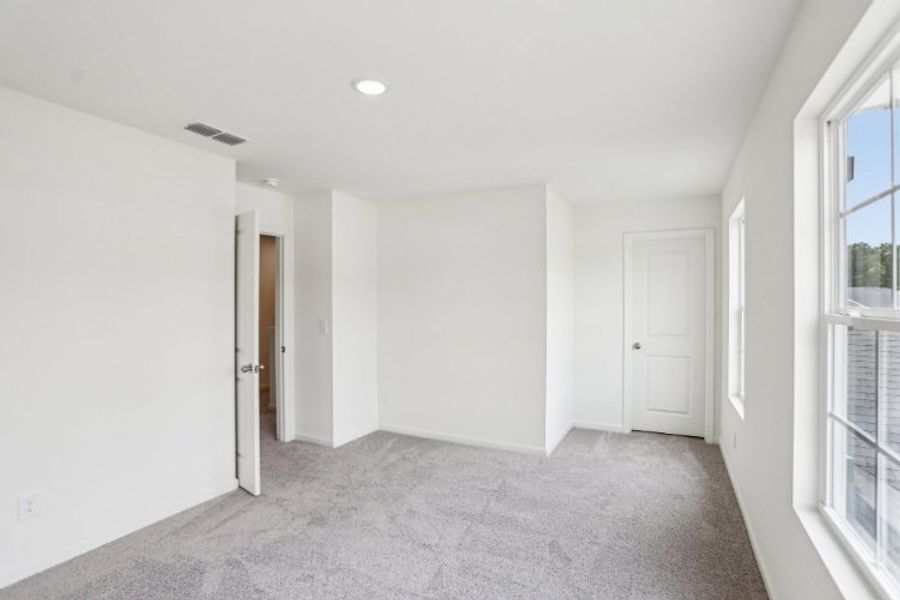 A hallway with white doors.