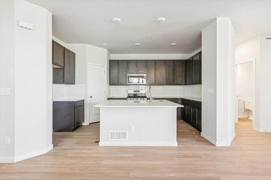 A kitchen with a white counter.