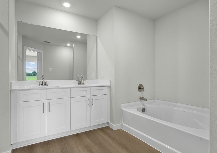 Spacious master bath has double-sink vanity and separate shower and tub. Spacious master bath has double-sink vanity and separate shower and tub.