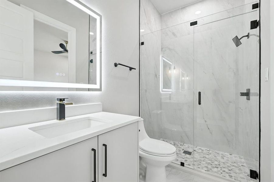 Bathroom with vanity, a marble finish shower, and light marble finish flooring Bathroom with vanity, a marble finish shower, and light marble finish flooring