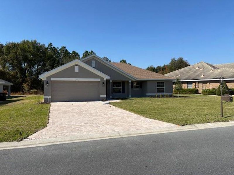 Front exterior of a new home in Juliette Falls, Dunnellon, FL, highlighting curb appeal (Image 1).