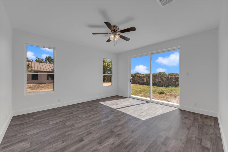 Sliding glass doors open from this versatile space onto the rear yard.