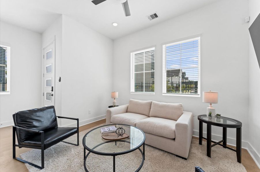 Bathed in natural light, this inviting living area offers serene views of the beautifully landscaped community courtyard creating a seamless connection between indoor comfort and outdoor charm. Bathed in natural light, this inviting living area offers serene views of the beautifully landscaped community courtyard creating a seamless connection between indoor comfort and outdoor charm.