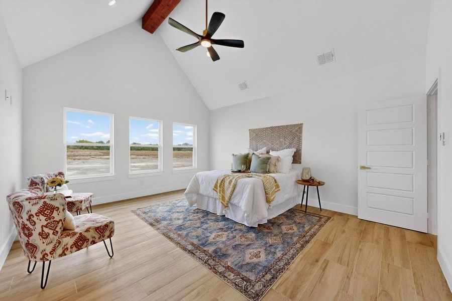 Bedroom with high vaulted ceiling, beamed ceiling, light wood finished floors, and ceiling fan
