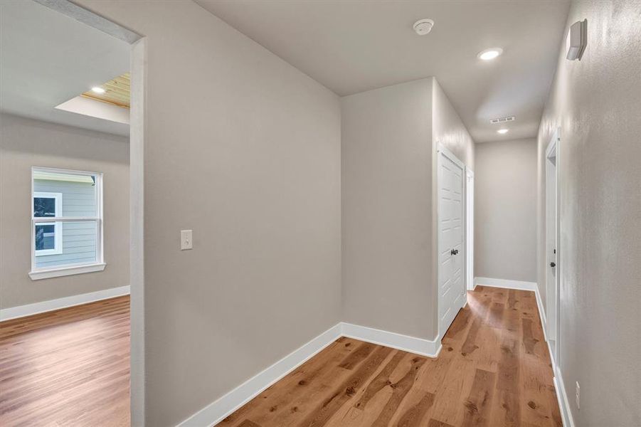 Hall featuring light wood-style flooring and recessed lighting Hall featuring light wood-style flooring and recessed lighting