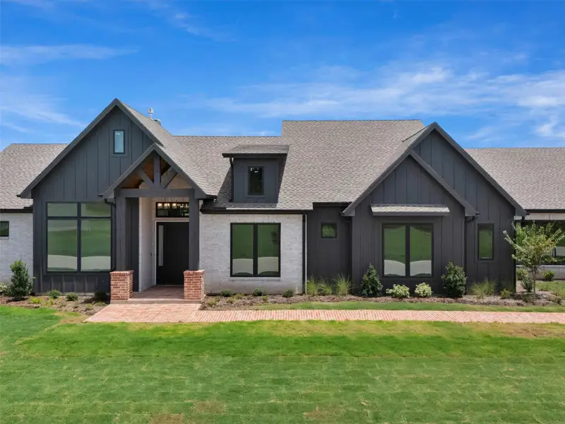 Front exterior of a new home in , Smithville, TX, highlighting curb appeal (Image 26).