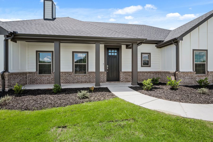 Front exterior of a new home in Saddleback Estates, Boyd, TX, highlighting curb appeal (Image 20).