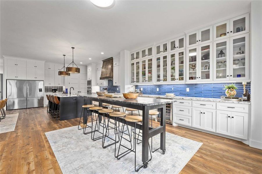Dining room featuring light wood-type flooring, wine cooler, and recessed lighting